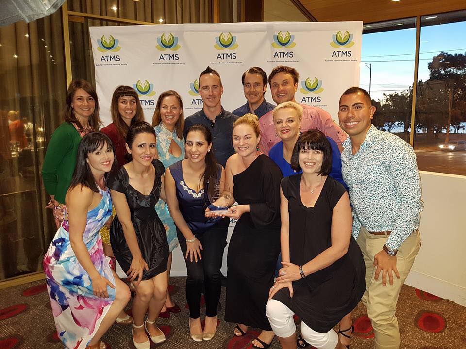 Jodie Coall and the Melbourne Natural Wellness team holding an ATMS industry award